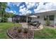 Entertainer's backyard featuring patio seating area, lush landscaping, and white exterior at 1313 Markley Dr, Largo, FL 33770