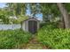 Backyard shed surrounded by lush greenery providing outdoor storage at 1313 Markley Dr, Largo, FL 33770