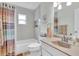 Bathroom with shower-tub combo and neutral tile at 1313 Markley Dr, Largo, FL 33770