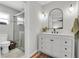 Bright bathroom featuring a sleek white vanity with a modern black framed mirror and updated shower at 1313 Markley Dr, Largo, FL 33770