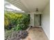 Inviting front porch with decorative stone flooring and lush greenery, creates a welcoming entrance at 1313 Markley Dr, Largo, FL 33770