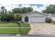 Charming single-story home with a well-maintained lawn and attractive stone driveway, showcasing curb appeal at 1313 Markley Dr, Largo, FL 33770