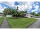 Well-manicured front yard with lush landscaping and healthy green grass surrounding a well maintained home at 1313 Markley Dr, Largo, FL 33770
