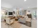 Spacious living room with comfortable seating, a ceiling fan, natural light, and a decorative rug at 1313 Markley Dr, Largo, FL 33770