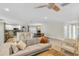 Open-concept living room flowing into the kitchen and dining area, featuring ample seating and a ceiling fan at 1313 Markley Dr, Largo, FL 33770