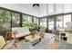 Relaxing sunroom with ample natural light and views of the surrounding greenery at 1313 Markley Dr, Largo, FL 33770
