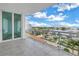 Condo balcony with tiled floors and white railings offers panoramic views of the marina and waterfront at 1325 Snell Isle Ne Blvd # 505, St Petersburg, FL 33704