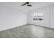 Bedroom featuring tile floors, a ceiling fan and a large window with water view at 1325 Snell Isle Ne Blvd # 505, St Petersburg, FL 33704