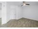 A simple bedroom area with white walls, tile flooring, and a ceiling fan at 1325 Snell Isle Ne Blvd # 505, St Petersburg, FL 33704