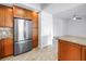 Modern kitchen featuring wood cabinetry, stainless steel appliances, and tile backsplash at 1325 Snell Isle Ne Blvd # 505, St Petersburg, FL 33704