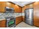 Kitchen detail featuring stainless steel appliances and hardwood cabinets, giving a luxury feel at 1325 Snell Isle Ne Blvd # 505, St Petersburg, FL 33704