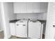 Laundry room featuring new washer and dryer appliances with overhead cabinet storage at 1325 Snell Isle Ne Blvd # 505, St Petersburg, FL 33704
