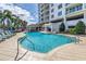 Relax by this sparkling pool with ample seating, palm trees, and a charming pergola for shade at 1325 Snell Isle Ne Blvd # 505, St Petersburg, FL 33704