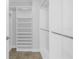 Walk-in closet featuring multiple shelves, hanging rods and tile floors at 1325 Snell Isle Ne Blvd # 505, St Petersburg, FL 33704