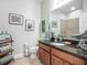 Charming bathroom features granite counters, framed mirrors and coastal decor at 13608 Artesa Bell Dr, Riverview, FL 33579