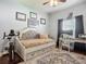 Cozy bedroom features neutral walls, area rug, ceiling fan and an ensuite desk area at 13608 Artesa Bell Dr, Riverview, FL 33579