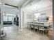 Elegant dining room with a modern chandelier, a large table, and views into the living area at 13608 Artesa Bell Dr, Riverview, FL 33579