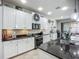 Modern kitchen features stainless steel appliances, granite countertops, and tile backsplash at 13608 Artesa Bell Dr, Riverview, FL 33579