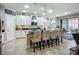 Stylish kitchen features white cabinetry, granite countertops and a breakfast bar at 13608 Artesa Bell Dr, Riverview, FL 33579
