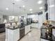Kitchen with a large island, stainless steel appliances, and white cabinets at 13608 Artesa Bell Dr, Riverview, FL 33579