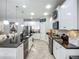 Modern kitchen features stainless steel appliances, granite countertops, and white cabinets at 13608 Artesa Bell Dr, Riverview, FL 33579