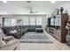 Bright living room boasts a large sectional sofa, area rug and media center at 13608 Artesa Bell Dr, Riverview, FL 33579