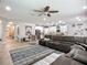 Spacious living room features a large sectional sofa and adjacent open-concept kitchen at 13608 Artesa Bell Dr, Riverview, FL 33579