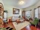 Spacious living room featuring hardwood floors, a comfortable couch, and classic decor at 13608 Artesa Bell Dr, Riverview, FL 33579
