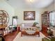 Bright and inviting living room with hardwood floors, a comfortable couch, and stylish decor at 13608 Artesa Bell Dr, Riverview, FL 33579
