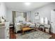 Main bedroom with hardwood floors, sitting bench, and a vanity with decorative lighting at 13608 Artesa Bell Dr, Riverview, FL 33579
