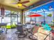 Screened-in patio featuring tile floors, ceiling fan and dining area with outdoor seating and grill at 13608 Artesa Bell Dr, Riverview, FL 33579