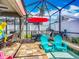Screened-in pool area with lounge seating, dining set, and outdoor grill, perfect for entertaining at 13608 Artesa Bell Dr, Riverview, FL 33579