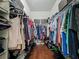 Walk-in closet with built-in shelving and ample storage space for clothing and accessories at 13608 Artesa Bell Dr, Riverview, FL 33579