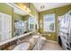 Bathroom with double sinks, granite countertops, tiled floors, and a shower-tub combo at 14042 Marlberry Way, Odessa, FL 33556