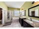 Bathroom featuring double sinks with granite countertops, a tub, and a glass shower stall at 14042 Marlberry Way, Odessa, FL 33556