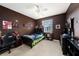 Cozy bedroom featuring brown walls with a bed, and shelves for storage at 14042 Marlberry Way, Odessa, FL 33556