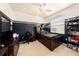 Bedroom with a combination of neutral and a dark navy blue painted accent wall at 14042 Marlberry Way, Odessa, FL 33556