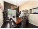 Elegant dining room boasts dark hardwood floors, wainscoting, contemporary chandelier, and ample natural light at 14042 Marlberry Way, Odessa, FL 33556