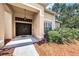Close-up of a home's inviting double-door front entrance with sidelights and manicured landscaping at 14042 Marlberry Way, Odessa, FL 33556