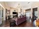 Bright living room featuring hardwood floors, ceiling fan, and sliding glass doors to the outdoor living area at 14042 Marlberry Way, Odessa, FL 33556