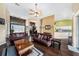 Open-concept living room boasts hardwood floors, large windows, and seamless flow to the kitchen and dining area at 14042 Marlberry Way, Odessa, FL 33556