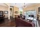 Open living room with hardwood floors offers views of the pool, kitchen, and dining areas for easy entertaining at 14042 Marlberry Way, Odessa, FL 33556