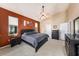 Spacious main bedroom with a high ceiling, a ceiling fan and an eye-catching accent wall at 14042 Marlberry Way, Odessa, FL 33556