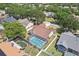 Aerial view of home featuring a screened-in pool and a well-maintained yard in a lush, green neighborhood at 1421 Buckner Rd, Valrico, FL 33596