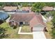 Aerial view of a home with a fenced yard, showcasing a well-manicured lawn and brick architectural details at 1421 Buckner Rd, Valrico, FL 33596