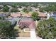 Aerial view of a residential neighborhood, featuring a home with mature trees and manicured lawns at 1421 Buckner Rd, Valrico, FL 33596