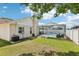 Exterior view of the home showcasing the screened pool and fenced yard at 1421 Buckner Rd, Valrico, FL 33596
