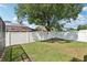 Backyard featuring well-maintained lawn and white vinyl fence surrounding the property at 1421 Buckner Rd, Valrico, FL 33596