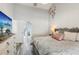 Bright bedroom with en suite bathroom featuring a view into the bathroom, a modern dresser, and a king-sized bed at 1421 Buckner Rd, Valrico, FL 33596