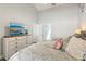 Bright bedroom featuring a view into the bathroom, modern dresser, and a king-sized bed at 1421 Buckner Rd, Valrico, FL 33596